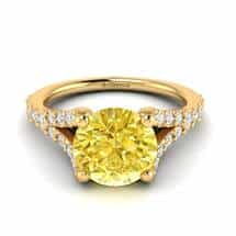 A mesmerising gold engagement ring with 6mm yellow Ceylon sapphire centre stone with four prongs.