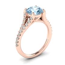 A unique rose gold engagement ring with pavé split shank set white cubic zirconia accent stones.