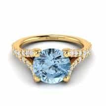 Yellow gold engagement ring with a four-pronged natural round cut 6mm aquamarine centre stone.