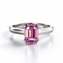 Pink sapphire solitaire engagement ring with slim white metal band