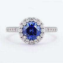 blue sapphire halo engagement ring with prominent accent stones