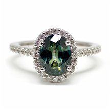 Green sapphire oval halo engagement ring with prong set band