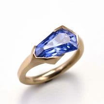 Blue sapphire engagement with distinct yellow gold metal band