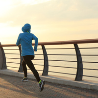 young fitness woman runner running at sunrise seaside