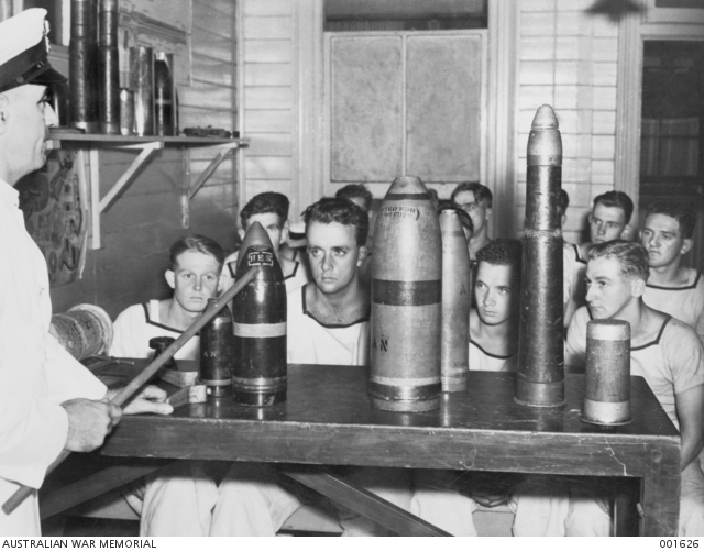 A RAN Petty Officer Gunnery Instructor giving a lecture to a group of ...