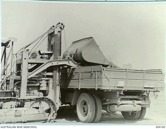 FRONT END LOADER IN OPERATION. SCOOPS, LIFTS AND DUMPS 3 TONS AT A TIME ...