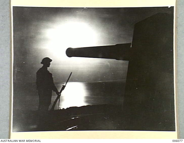 TAKEN AT NIGHT, A SENTRY ON GUARD BY A 9.2 COASTAL DEFENCE GUN ...
