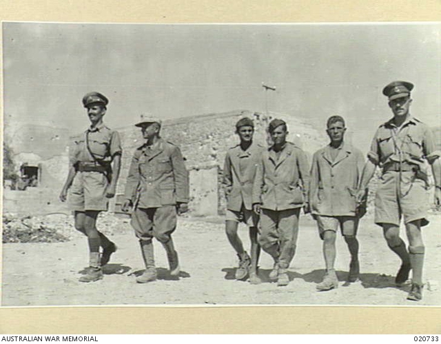 A German and three Italian prisoners of war with their escort ...