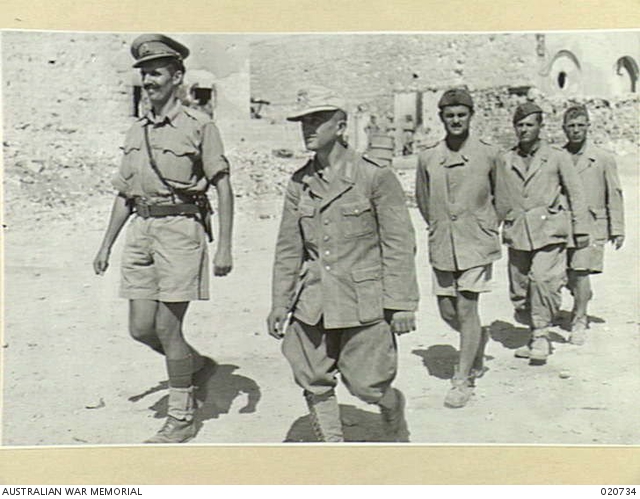 A German and three Italian prisoners of war with their escort ...