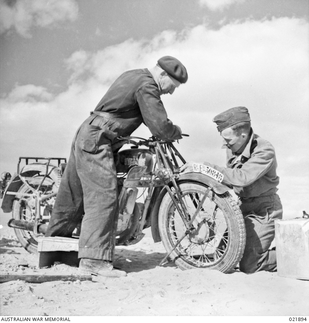 Mechanics of No. 3 Squadron, RAAF, making repairs to a a captured ...
