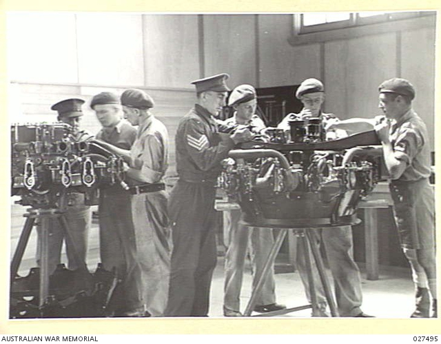 Group portrait of unidentified students working in the engine class ...