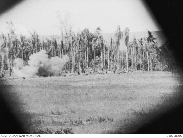 Sanananda, Papua. January 1943. An exploding shell near the palm trees ...