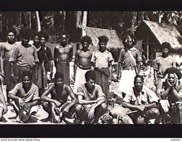 REINHOLD HIGHWAY, NEW GUINEA, 1943-08-31. NATIVE ROAD WORKERS OUTSIDE ...