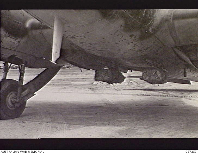 LAVERTON, VIC. 1943-10-02. PACKAGES HANGING FROM AVRO ANSON BOMB RACKS ...