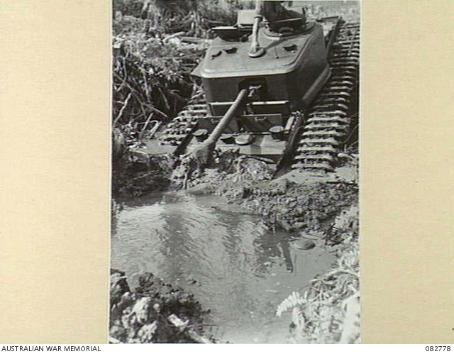 MADANG, NEW GUINEA. 1944-10. A CHURCHILL VII TANK BOGGED IN MUD AND ...