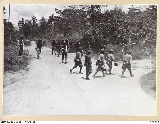 RABAUL, NEW BRITAIN, 1945-09-10. JAPANESE TROOPS CROSSING THE ROAD IN ...
