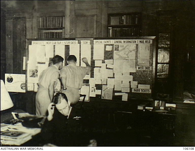 New York, USA. 1944. Two soldiers reading notes on the Bulletin Board ...