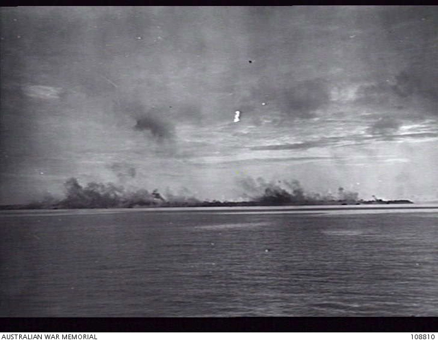 LABUAN, NORTH BORNEO, 1945-06-10. SHELLS AND BOMBS BURSTING ON BROWN ...