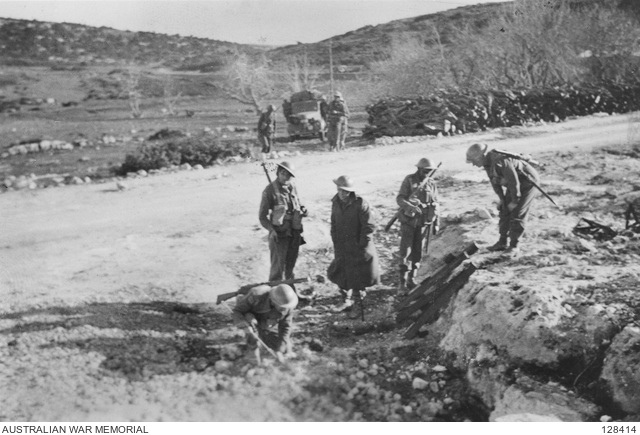 LIBYA, NEAR DERNA, 1941-01. AN ENGINEER PROBING FOR ANTI-TANK MINES TO ...