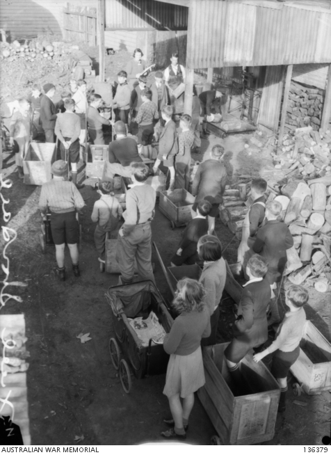 CHILDREN, WITH THEIR PRAMS AND BILLY CARTS LINING UP AT THE WOODYARD TO ...