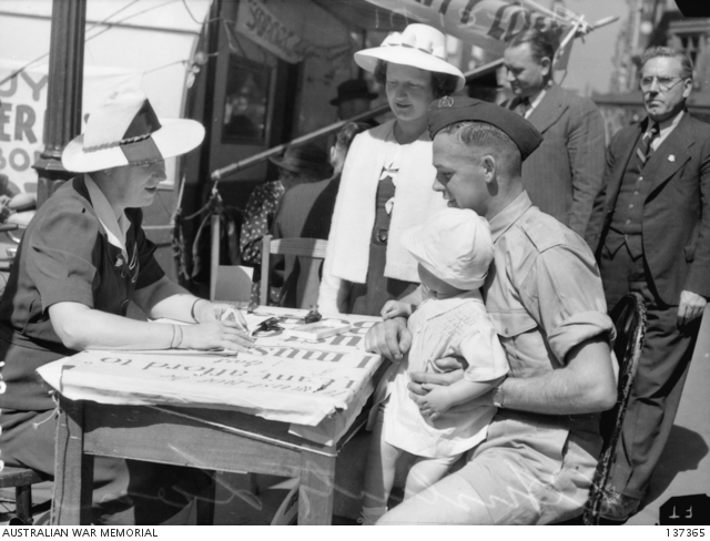 MELBOURNE, VIC. 1942-12-14. A MEMBER OF THE RAAF ACCOMPANIED BY HIS ...