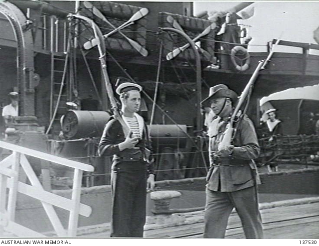MELBOURNE, VIC. 1942-12-31. A FREE FRENCH SAILOR STANDS GUARD AT THE ...