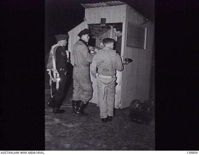 POINT COOK, VIC. 1943-10-02. RAAF AIR CREW CONSULT THE OFFICER-IN ...