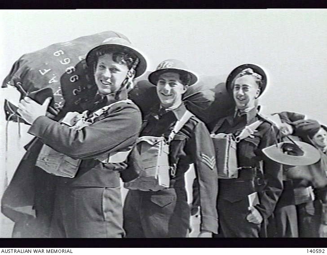 MELBOURNE, VIC. 1944-03-15. RAAF AIRCREW CARRING THEIR KITBAGS ABOARD ...
