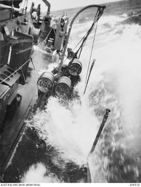 THE DEPTH CHARGE STORAGE RACKS, LOADING DAVIT AND LAUNCHER ABOARD THE ...
