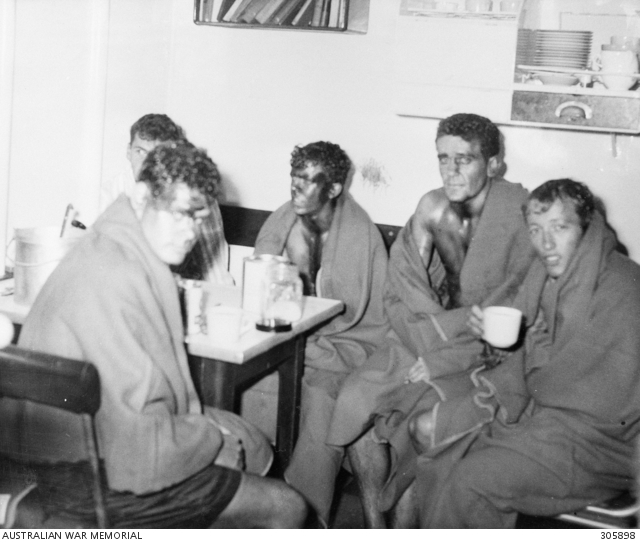 JERVIS BAY, ACT. 1964-02-10. WRAPPED IN BLANKETS, OIL COVERED SURVIVORS ...