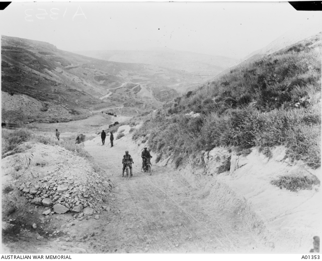 Two German despatch riders on their bikes, three men are walking on the ...