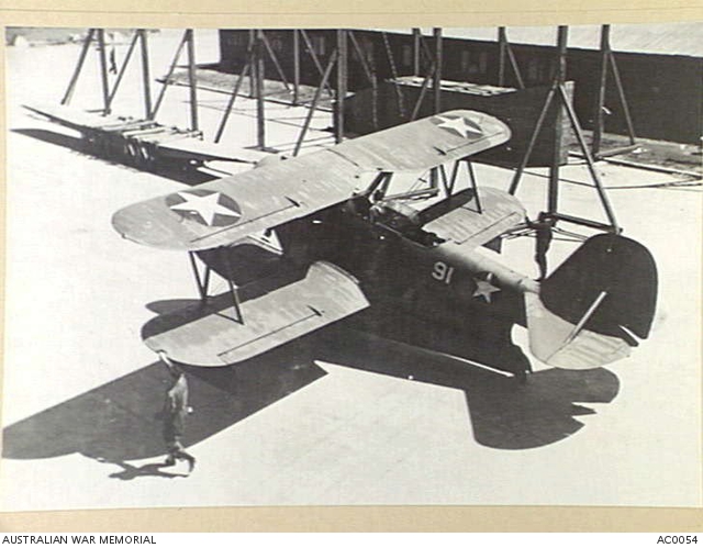 A GRUMMAN AMPHIBIAN OF THE U.S. NAVY SHOWN TAXIING IN THE HANGAR AREA ...