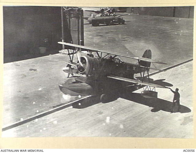 A GRUMMAN AMPHIBIAN OF THE U.S. NAVY SHOWN TAXIING IN THE HANGAR AREA ...