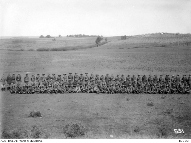 Outdoors group portrait of unidentified members of the Machine Gun ...