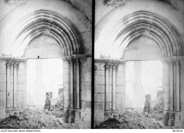 Interior view of a damaged mosque. A local man is standing among the ...