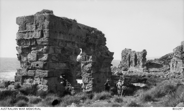 Three unidentified soldiers standing next to the ruins at Atlit, south ...