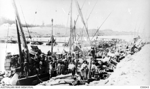 Men and officers engaged in unloading 50th Battalion's stores on the ...