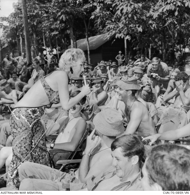 Nui Dat, South Vietnam. December 1970. Sharing a joke with a soldier is Lorrae Desmond, star of ... | Australian War Memorial