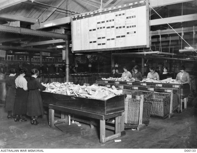 Sorting newspapers at the Australian Base Post Office, showing key to ...