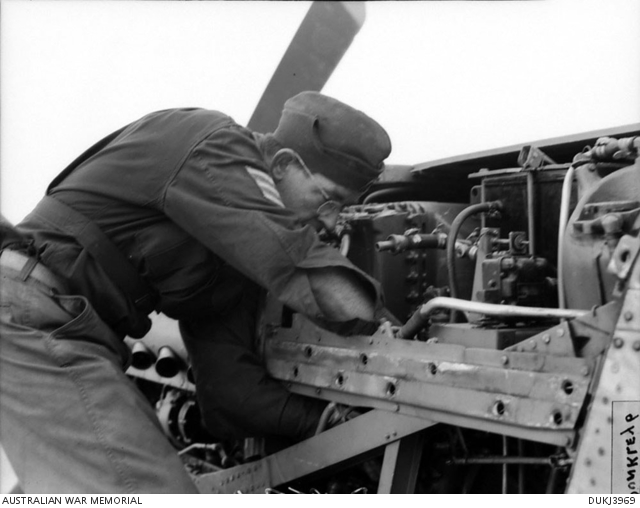 An unidentified 77 Squadron RAAF sergeant servicing the engine of one ...