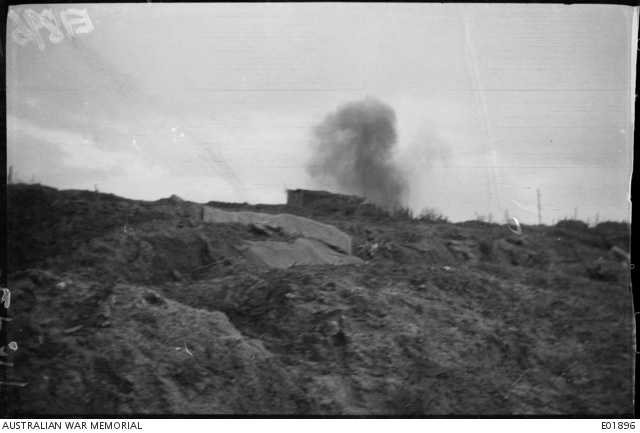 A German shell bursting near a concrete pillbox on Broodseinde Ridge in ...
