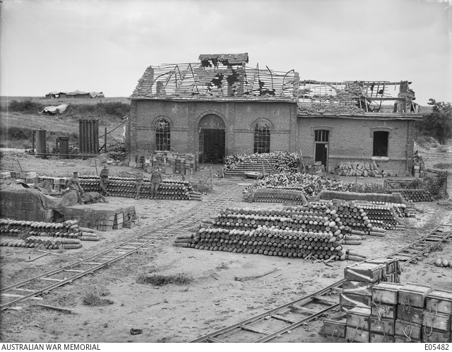 View of an ammunition dump showing rows of stacked shells and piles of ...