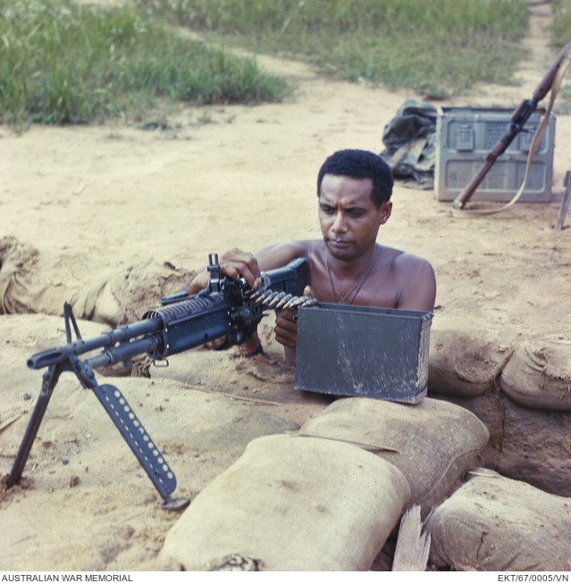 South Vietnam. 1967. Digger feeding ammunition belt into a 7.62mm GPMG