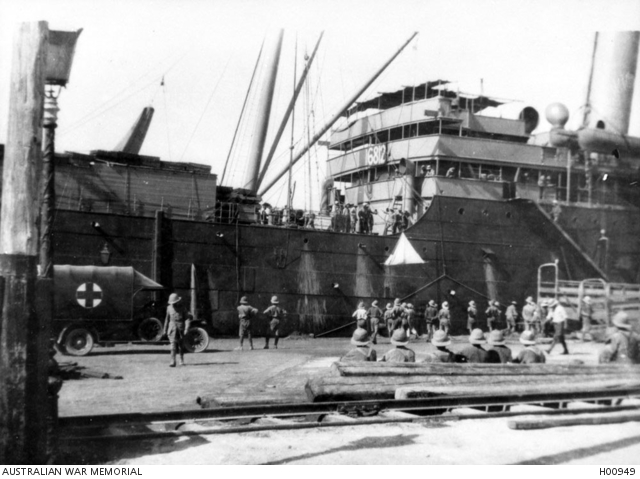 Wounded from Palestine being unloaded by sling from a ship for movement ...