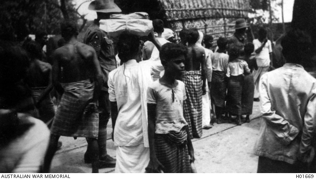 COLOMBO, CEYLON. 1919. TWO AUSTRALIAN SOLDIERS AMIDST A NUMBER OF YOUNG ...