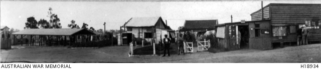 A VIEW AT THE INTERNMENT CAMP SHOWING ABLUTION BENCHES, CAFE AND CAMP ...