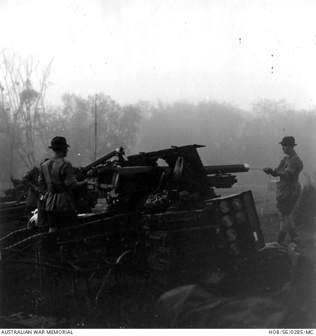 Silhouetted against the dawn mist, Number 2 (B2) gun crew of B Troop ...