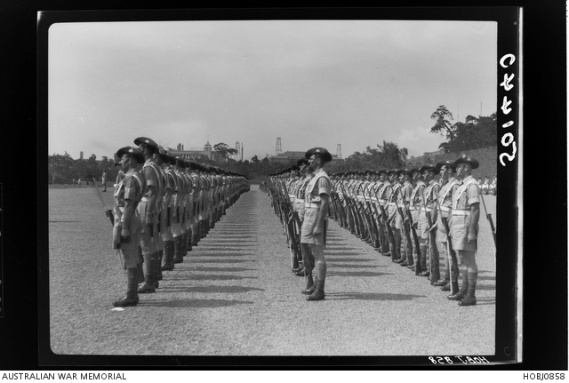 Unidentified Australian Army Servicemen stand at ease at a British ...