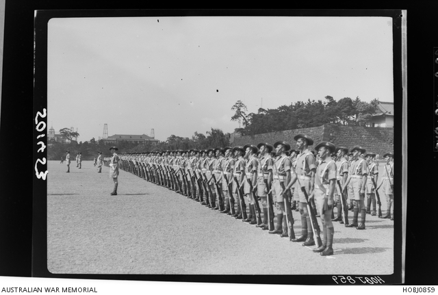 Unidentified Australian Army Servicemen stand at ease at a British ...