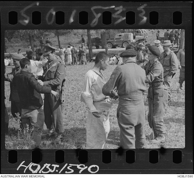 British troops search North Korean prisoners of war (POWs) at a ...